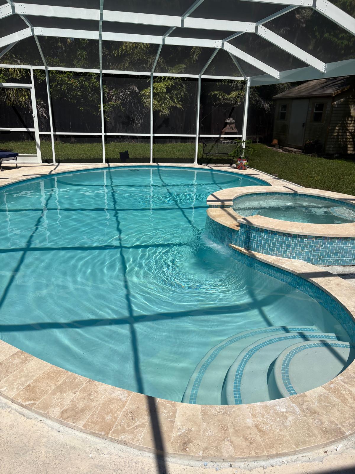Backyard pool with spa and tile step entry.